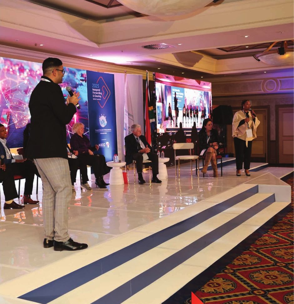 Speaker addressing a panel on stage at the Forwarding and Clearing Skills Summit