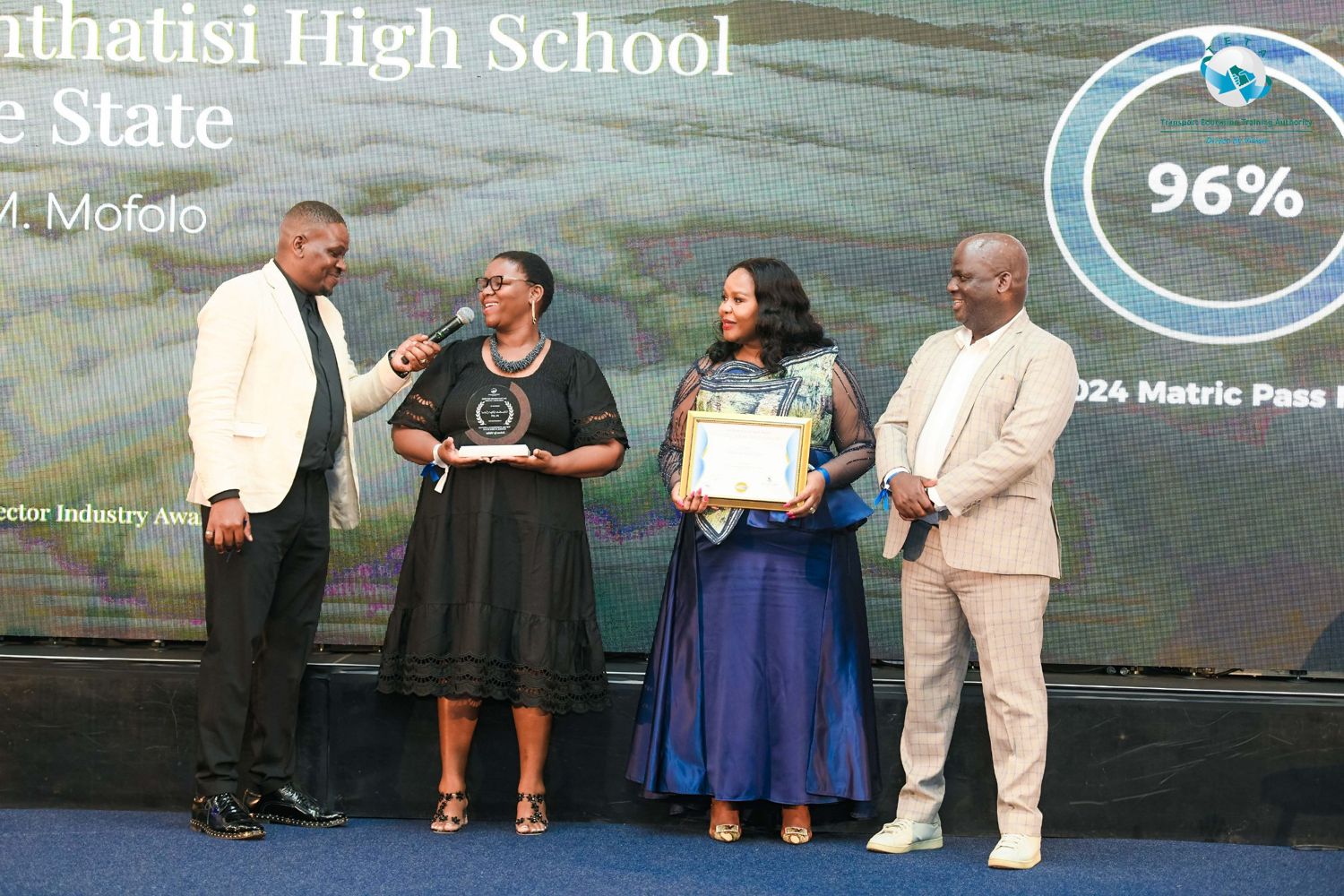 Award winners on stage in front of a slide showing a 96% matric pass rate
