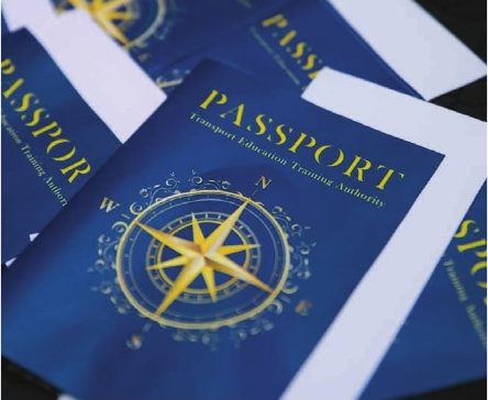 Navy passport-style event programme with gold compass